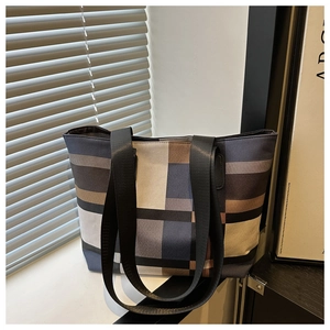 Close-up of stylish large-capacity tote bag with multi-color plaid design and wide straps