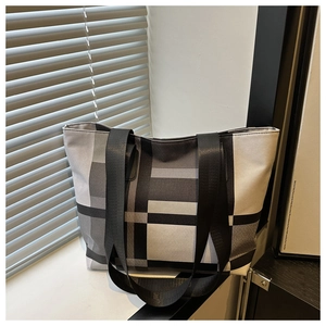 Detail of large-capacity tote bag with black, white, and grey checkered canvas pattern