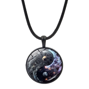 Macro shot of Yin Yang pendant with cosmic nebula art under a clear glass dome
