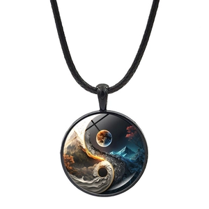 Macro detail of round yin yang pendant with nature landscape art and black wax rope cord
