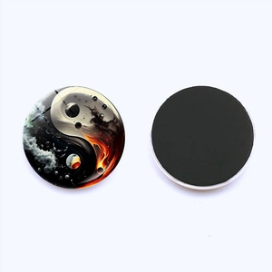 Detail of 25mm Yin Yang Tai Chi glass fridge magnet with flame and water crystal texture