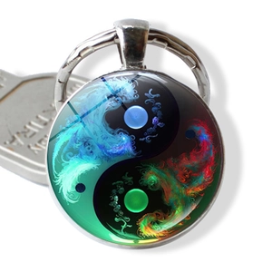 Detailed view of Yin Yang Tai Chi keychain with vibrant nebula flame patterns and glass dome