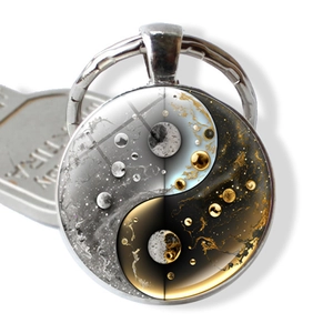 Detailed close-up of Yin Yang Tai Chi keychain with celestial galaxy and gold leaf patterns