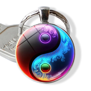 Artistic Yin Yang keychain featuring colorful gradient flames and polished silver frame