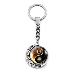 Rotating Yin Yang Tai Chi keychain with silver crescent moon frame and gold detailing