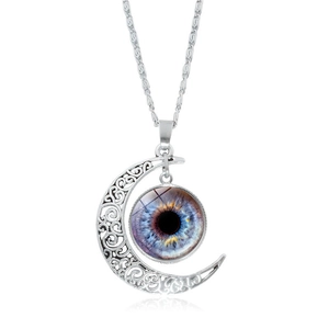 Detailed view of silver crescent moon pendant with intricate filigree and blue eye iris gem