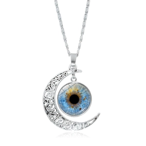 Detail of silver crescent moon necklace featuring a realistic blue glass eyeball pendant