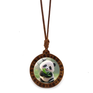 Detail showing a round wooden pendant with cartoon panda and green bamboo art