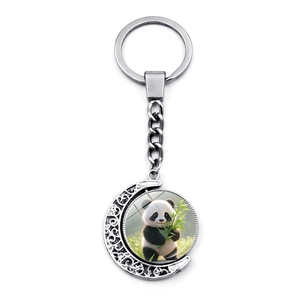 Moon-shaped rotating panda keychain with silver metal hollow frame and cute cartoon charm