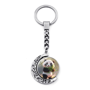 Close-up of rotating moon-shaped panda keychain with decorative hollow patterns