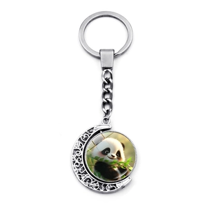 Close-up of a silver moon-shaped panda keychain with a rotating double-sided pendant