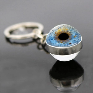Macro shot of eye pupil keychain with blue iris crystal glass ball and silver metal ring