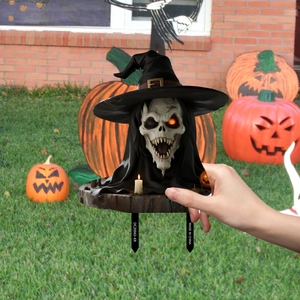 Halloween garden stake featuring skeleton in wizard hat with pumpkin and candle base