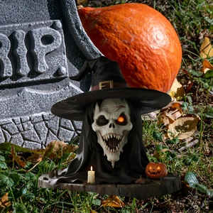 Detailed view of Halloween skeleton in wizard hat with mini pumpkin and candle on wood base