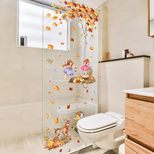 Fall window decals featuring autumn leaves, fairies, and forest animals on glass