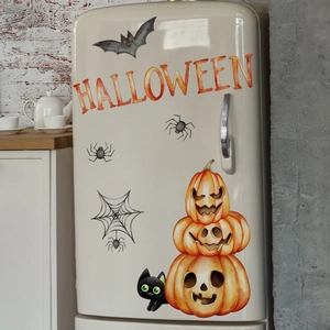 Close-up of hand-painted Halloween wall decals with pumpkins and black cat on a fridge