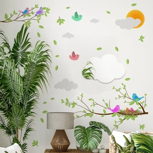 Cartoon wall stickers set with birds, tree branches, and clouds on a living room wall