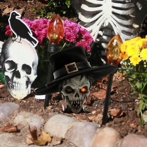 Halloween garden skull stake with black top hat and glowing orange eye decoration