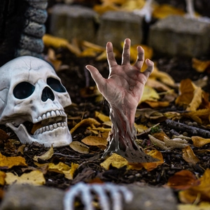 Halloween garden decor set with realistic zombie hand and skull rising from the dirt