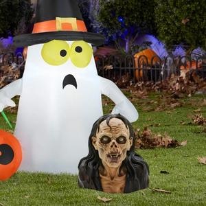 Detailed outdoor Halloween scene with tall inflatable ghost and realistic long-haired zombie bust