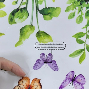 Detail of double-sided butterfly window sticker with adhesive backing and vivid leaf patterns