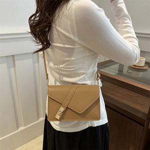 French vintage khaki crossbody bag with gold lock buckle and adjustable strap shown on model