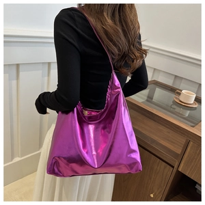 Detail of purple metallic tote bag with high-gloss mirror finish and wide shoulder strap