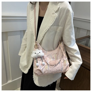 Détail du sac cabas rose gaufré avec broderies et pendentif nuage en peluche