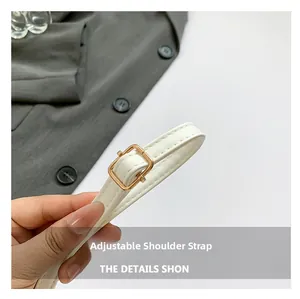 Detail of adjustable white PU leather strap with premium gold buckle and stitching