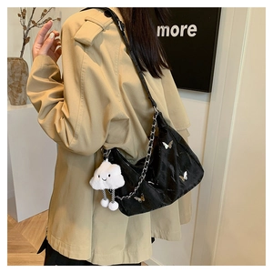 Stylish black shoulder bag with chain strap, cute butterfly decor and fluffy cloud pendant.