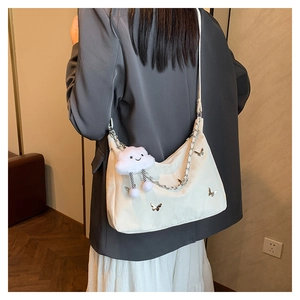 White butterfly shoulder bag with silver metallic charms and plush cloud pendant
