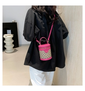 Detail view of pink leather and monogram canvas bucket bag with adjustable strap