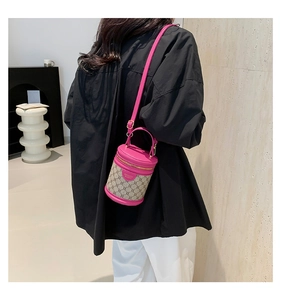 Detail view of a mini bucket bag in rose pink leather and classic brown monogram fabric