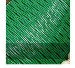 Macro shot of green pleated shell bag texture with pearl accents and metallic chain