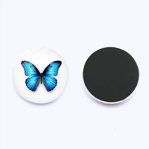 Detail of 25mm crystal glass fridge magnets with realistic blue butterfly patterns and magnetic back
