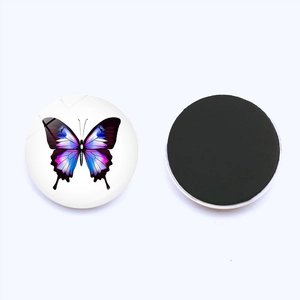 Detail view of round 25mm butterfly glass fridge magnet showing front pattern and magnetic back