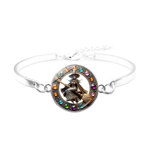 Detail of silver witch bracelet with a glass pendant and rainbow rhinestone embellishments