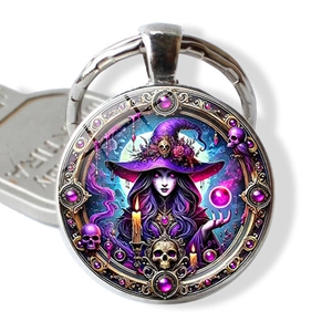 Macro detail of witch keychain with purple gemstones and miniature skull charm