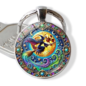 Detailed view of witch on broomstick illustration in circular glass pendant keychain