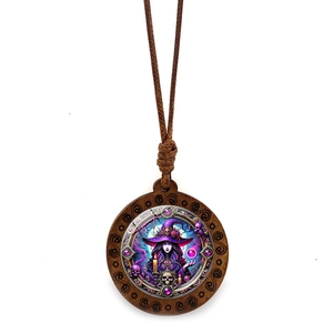 Detail of wooden witch pendant necklace with purple mystic art on a white background