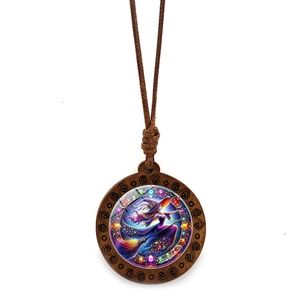 Macro detail of wooden witch pendant with colorful resin inlay and woven cord strap