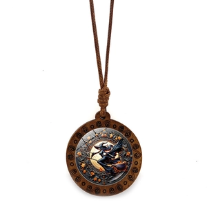 Detailed view of wooden Halloween necklace with flying witch and autumn maple leaf design