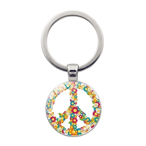 Macro detail of silver car keychain with colorful floral peace sign charm pendant