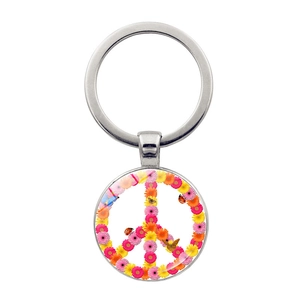 Detail of floral peace sign keychain featuring colorful daisies and butterfly charm