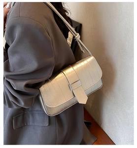 Metallic silver rectangular shoulder bag with horizontal quilted texture and slim strap