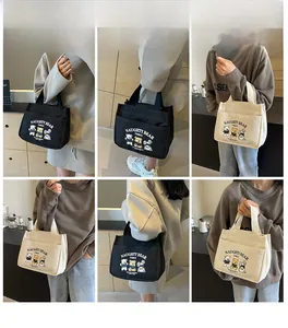 Multiple views of cartoon bear canvas tote bags shown in white and black styles