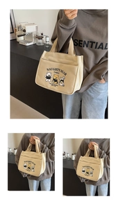 Detail of oatmeal canvas tote bag featuring cute cartoon bears and sturdy handles