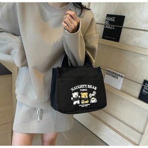 Black canvas tote bag with cartoon bears print and outer pocket for casual daily use