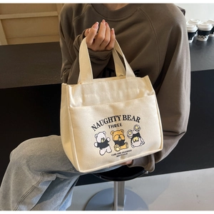 Detail of canvas tote bag featuring cute cartoon naughty bears and front pocket