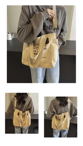 Detail of light beige canvas tote bag with wide straps and artistic graphic print